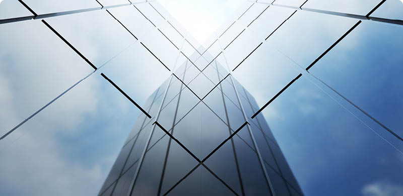 Low angle view of generic modern office skyscrapers ,high rise buildings with abstract geometry glass facades on a bright sunny day . Concepts of finances and economics background. 3d rendering .
