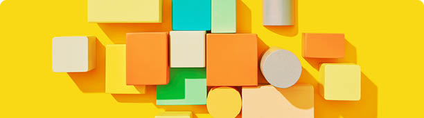 Geometrical pattern from multicolored wooden cubes and blocks different size and shapes on a yellow background with hard shadows, copy space. Teamwork project collaboration business concept. Top view.